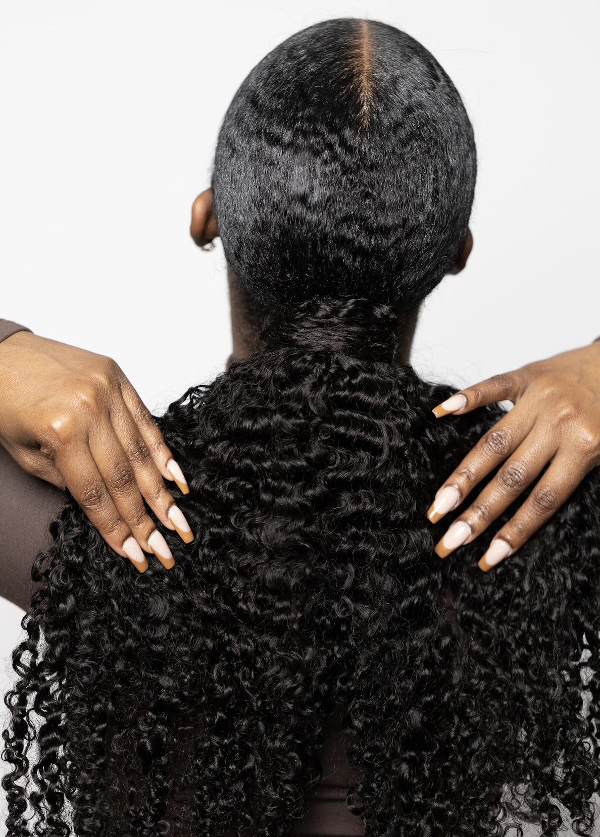 Corkscrew curly wrapped ponytail back view